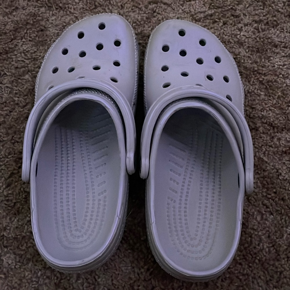 silver crocs, size 9 in women’s.